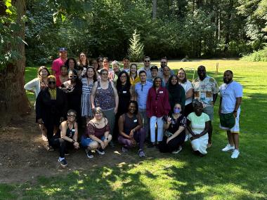 A photo of the Office of Equity team at their Summer BBQ in July 2024. A large group of varied individuals smile at the camera.