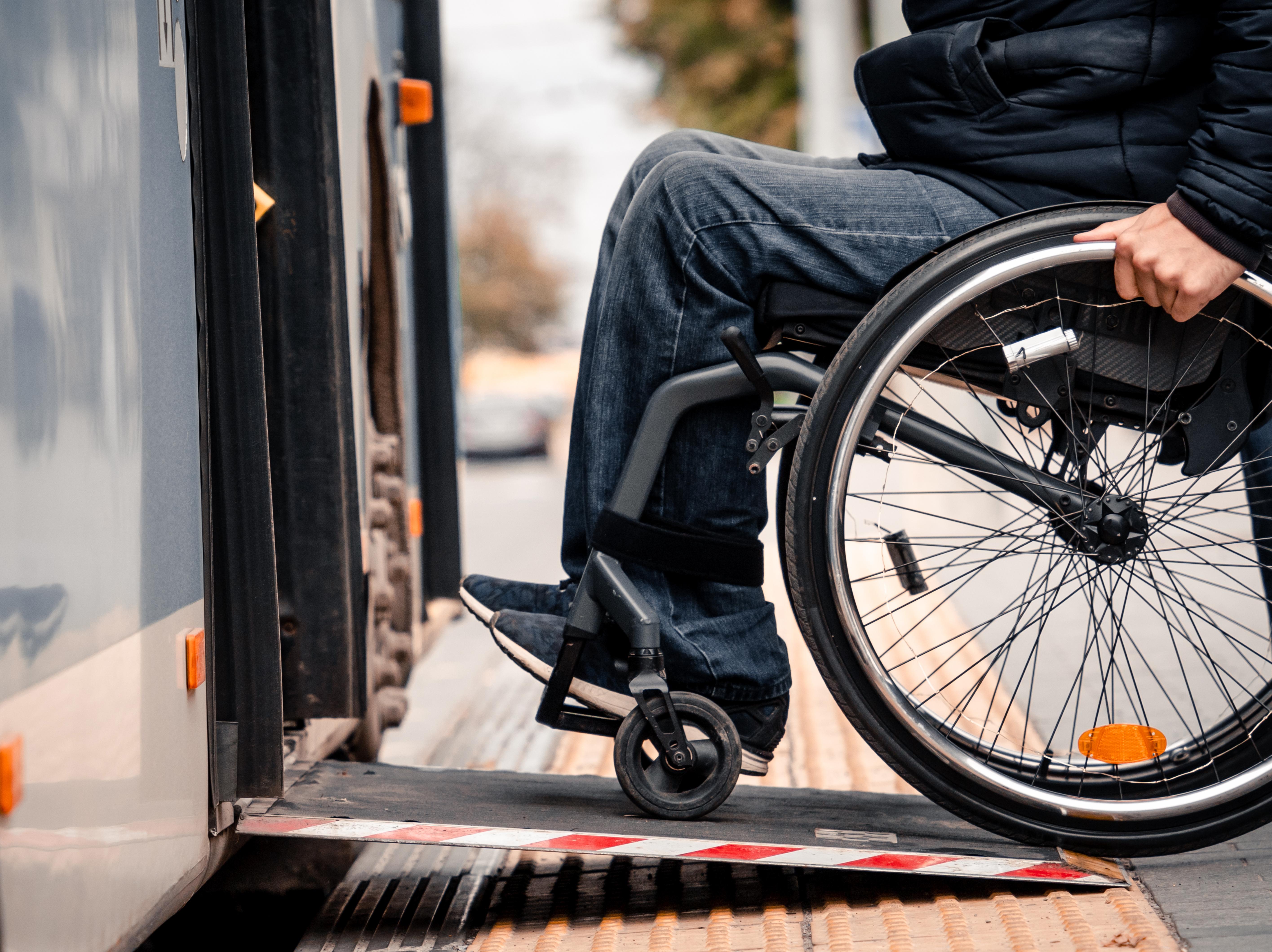 a person in a wheel chair boards a bus