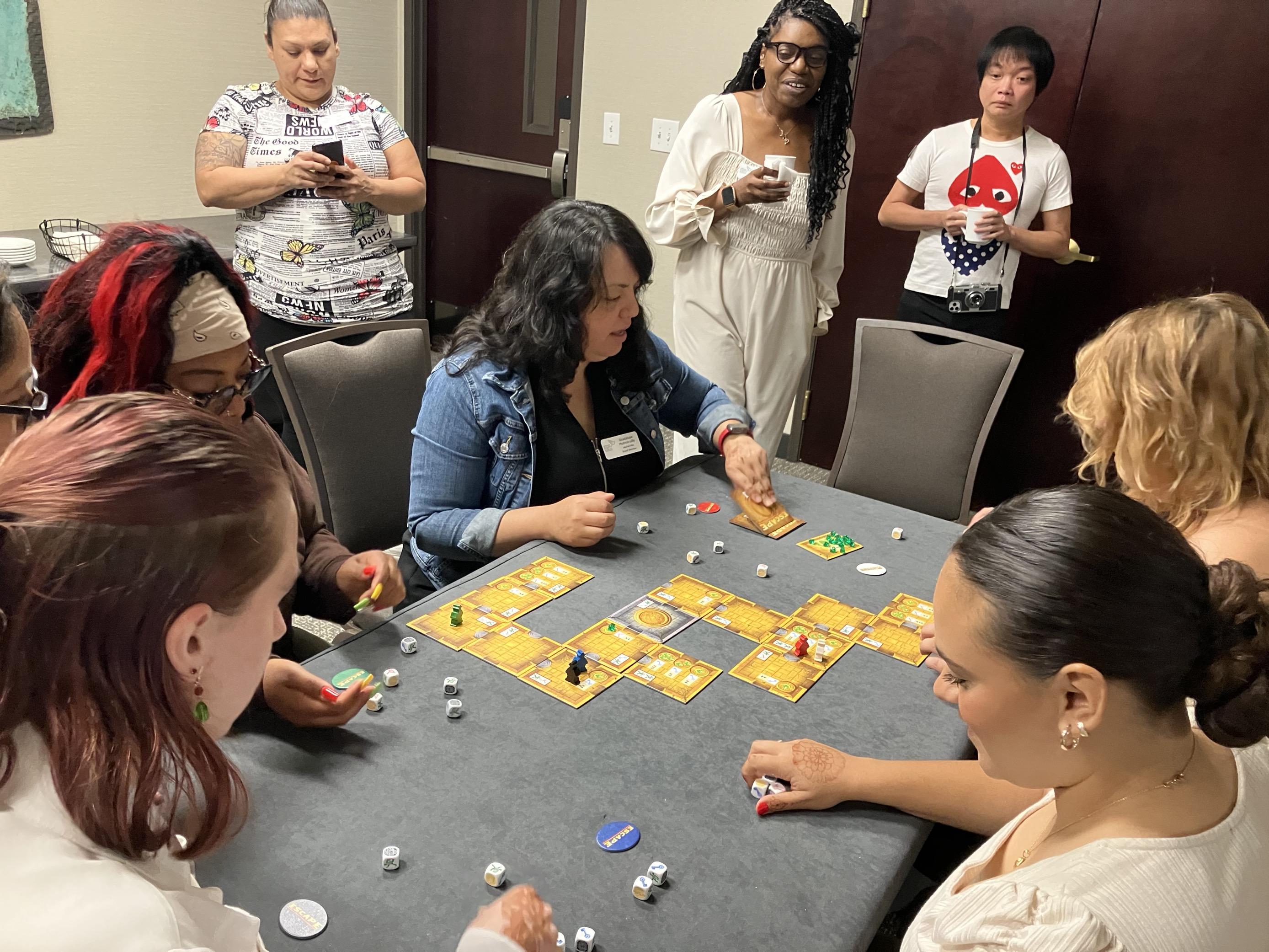 Group of people sitting around a table doing an activity.