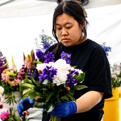 Vendor holding flowers.